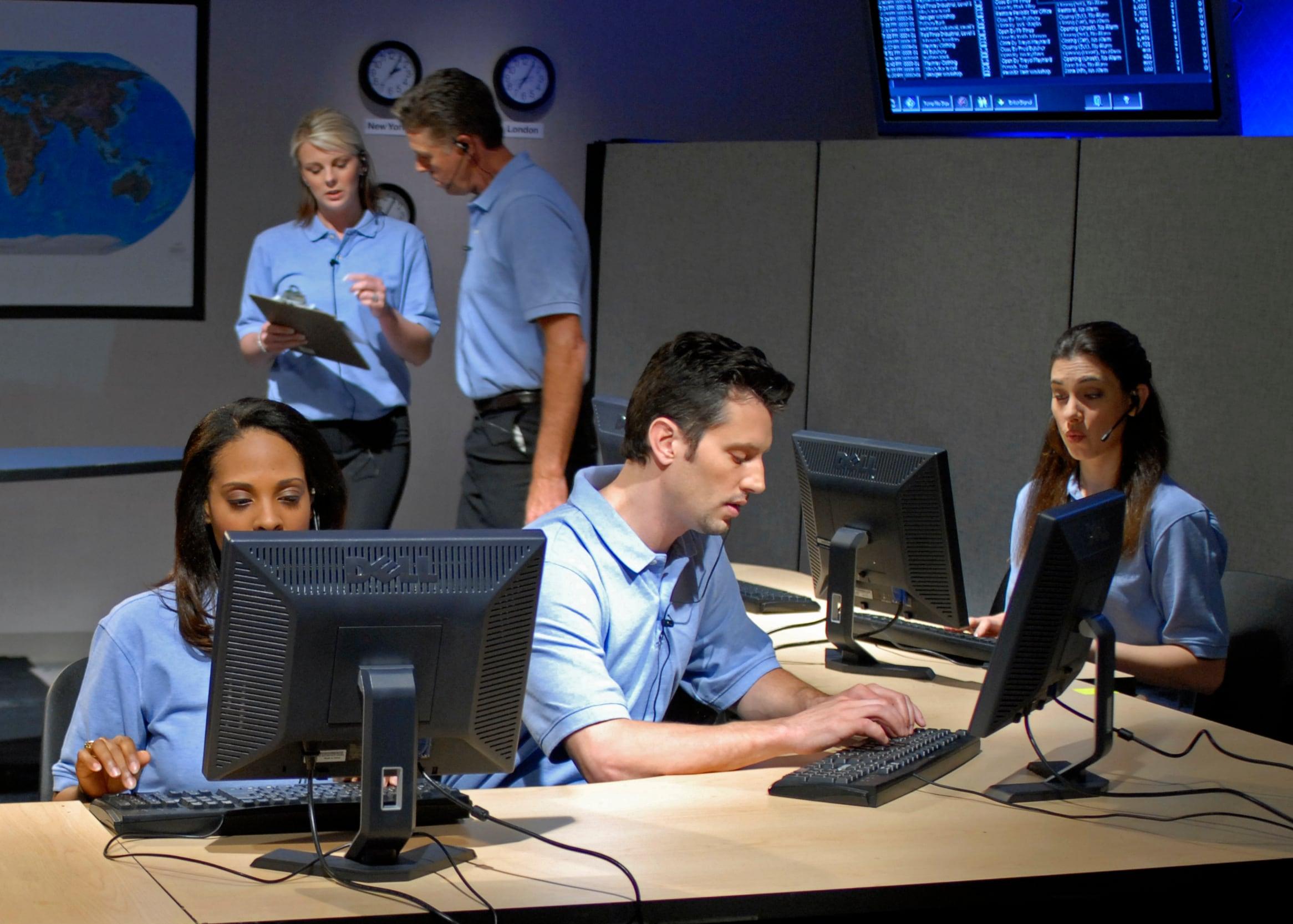 Monitoring center operators watching for fire alarm signals around the clock